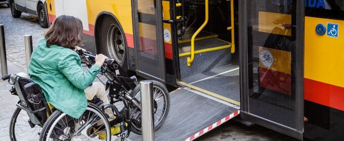 woman on wheelchair entering bus