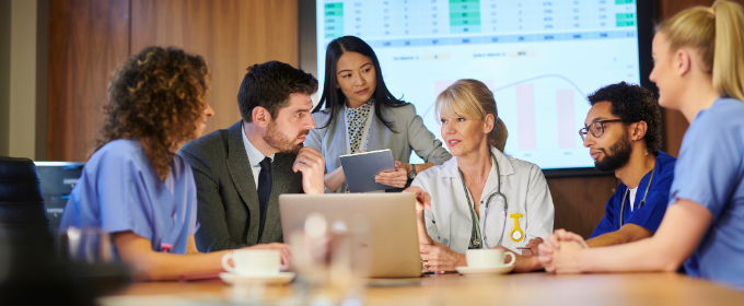 Doctors and Health professionals sat around a desk