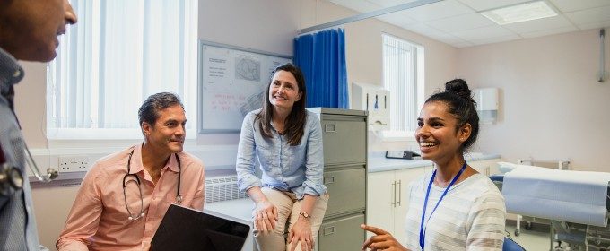 Doctors hold a staff meeting in a treatment room at a general practitioner's surgery