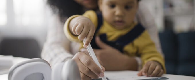 Woman holding a baby while working